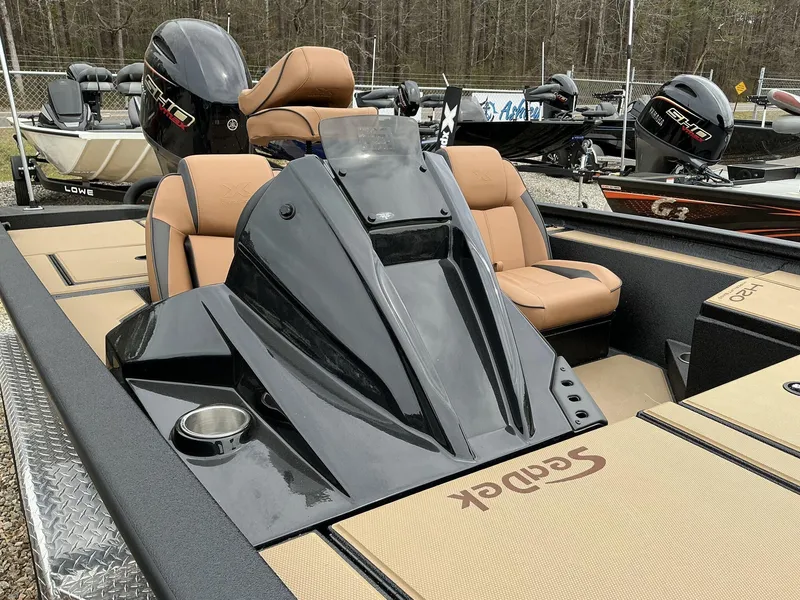 Slide: The Image of 2025 Xpress Hyper-Lift Bass Series boat with tan seats and sleek black console. - 6