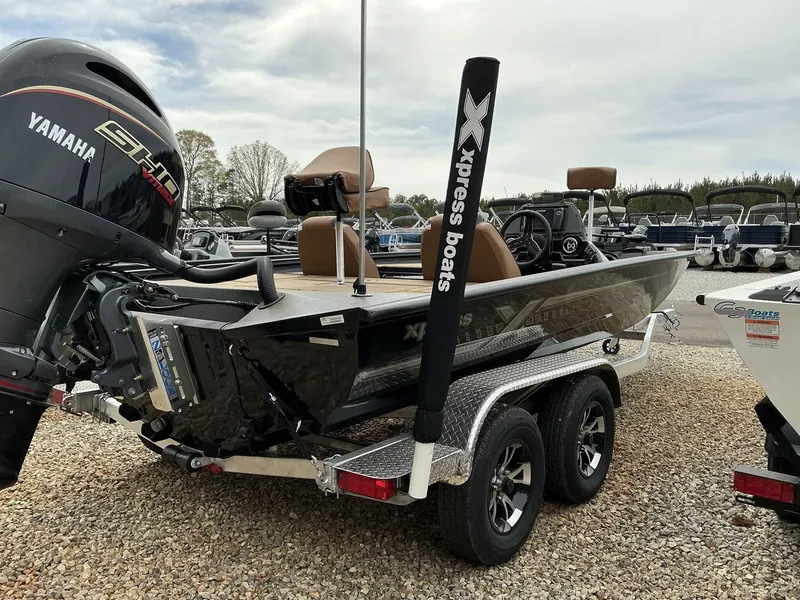 Slide: The Image of 2025 Xpress Hyper-Lift Bass Series boat with Yamaha engine on a trailer. - 8