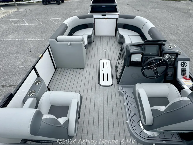 Slide: The Image of 2025 Veranda Relax Series 22RC pontoon boat interior with gray seating and modern dashboard. - 10