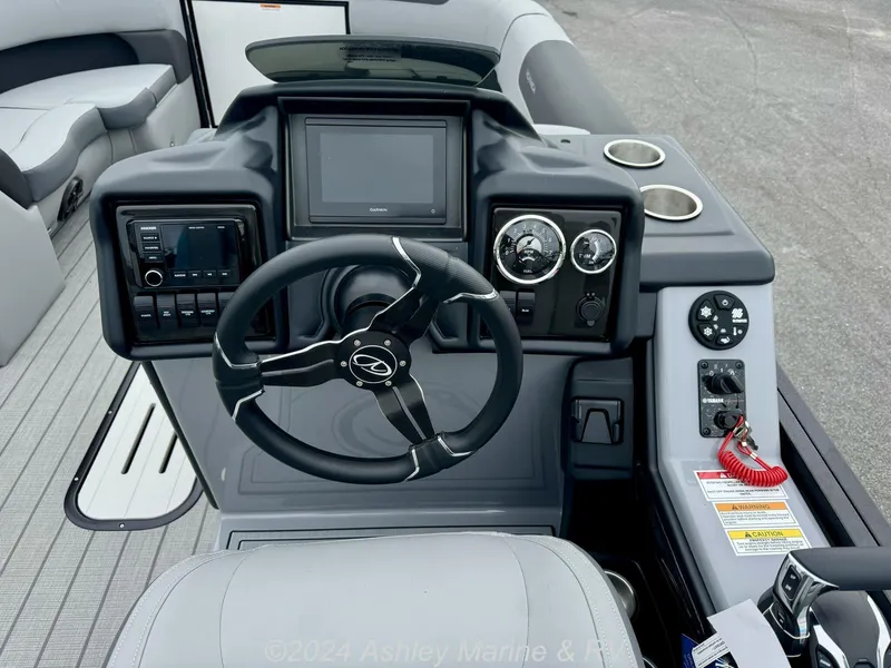 Slide: The Image of 2025 Veranda Relax Series 22RC boat dashboard with steering wheel and control panel. - 8