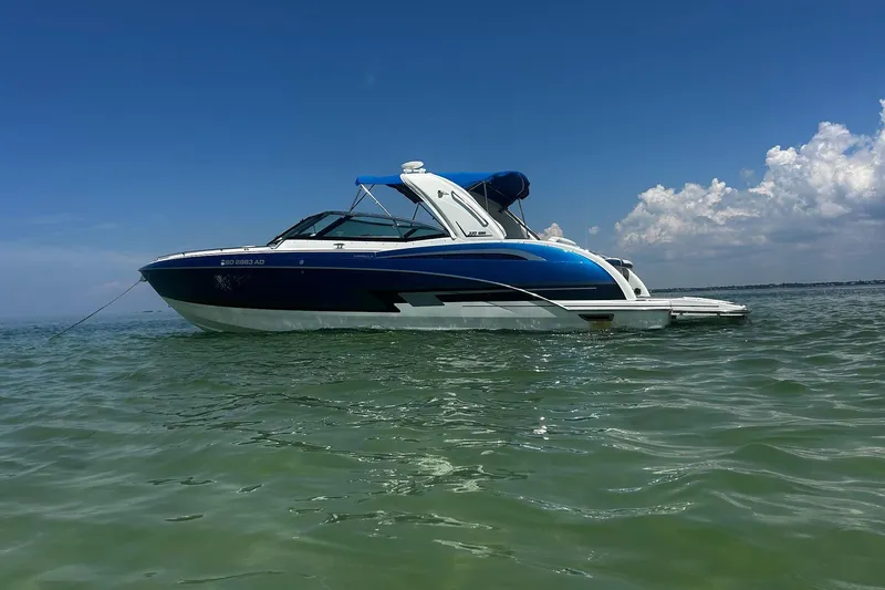 The Image of 2017 Formula 350 Crossover Bowrider OB on calm water under clear blue sky. - 0