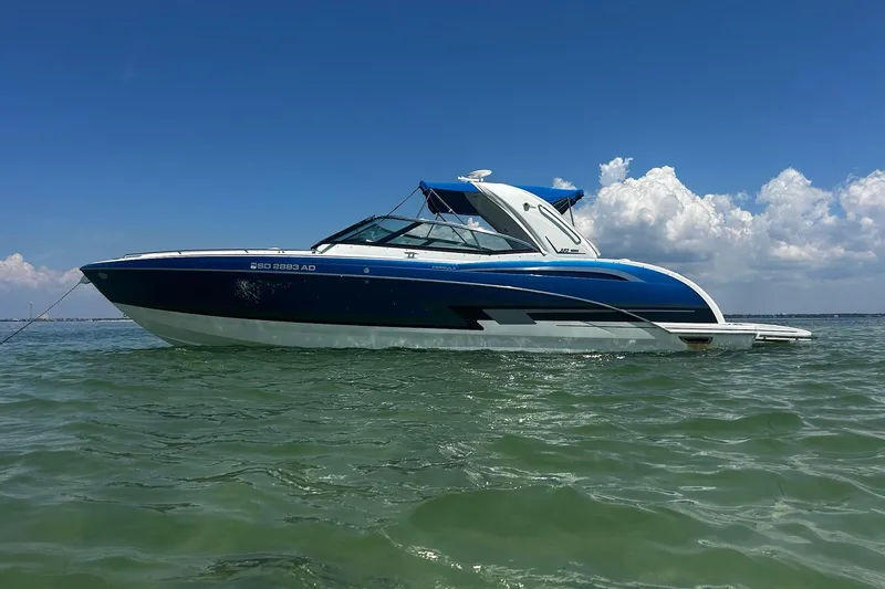 Slide: The Image of 2017 Formula 350 Crossover Bowrider OB on calm water under blue sky. - 1