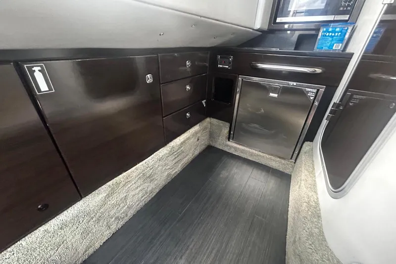 Slide: The Image of Interior of 2017 Formula 350 Crossover Bowrider OB with sleek cabinetry and modern appliances. - 13