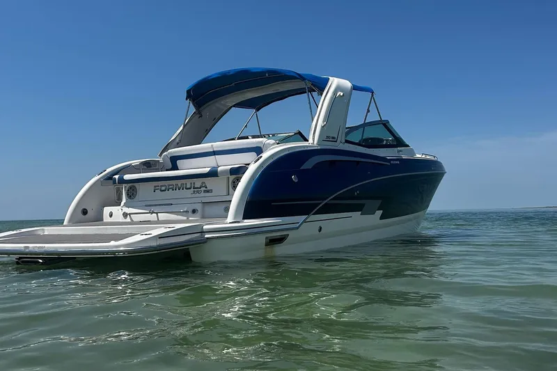 Slide: The Image of 2017 Formula 350 Crossover Bowrider OB on calm water, blue sky background. - 3