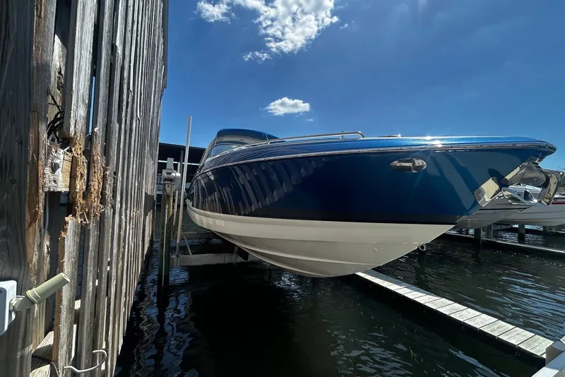 Slide: The Image of 2017 Formula 350 Crossover Bowrider OB docked, blue hull, sunny day. - 7