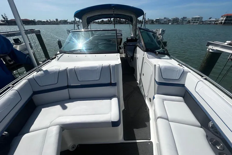 Slide: The Image of 2017 Formula 350 Crossover Bowrider OB, spacious seating, docked by waterfront homes. - 8