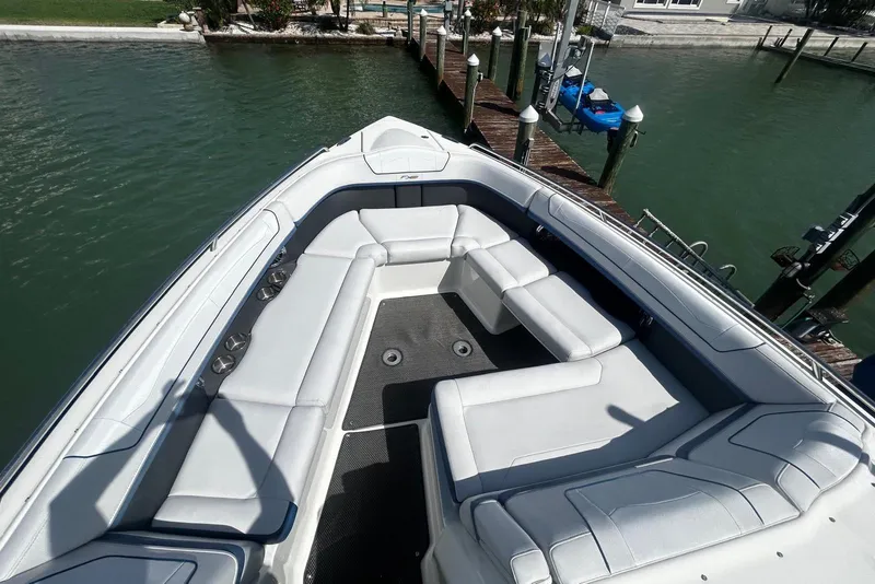 Slide: The Image of 2017 Formula 350 Crossover Bowrider OB with spacious seating at dockside. - 9