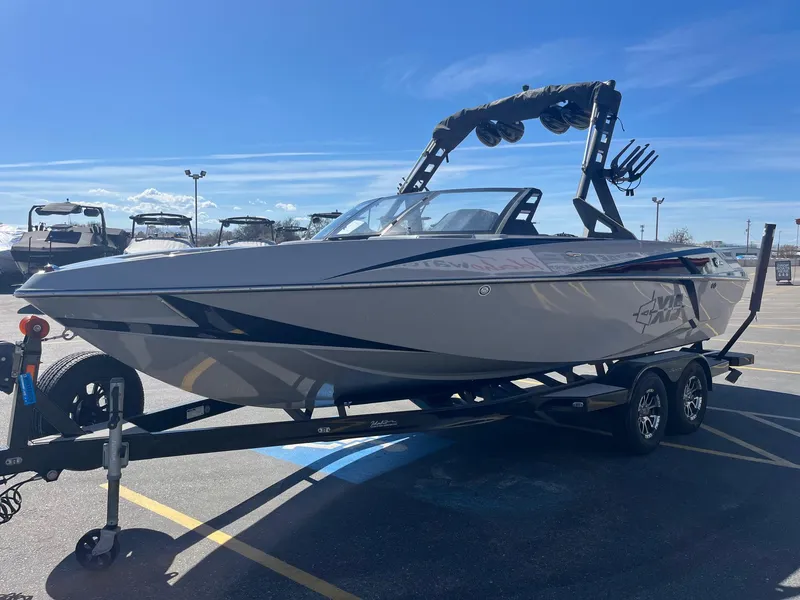 Slide: The Image of 2017 Axis Boats T22 on trailer under clear blue sky. - 10