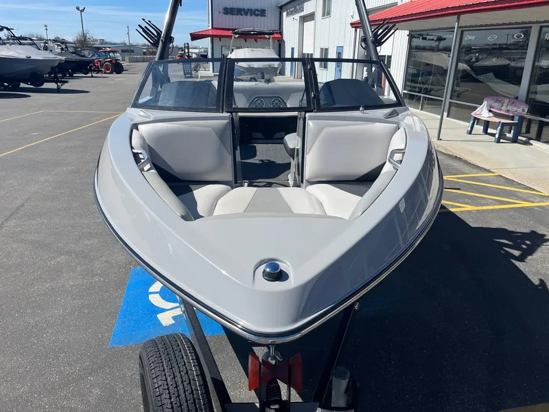 Slide: The Image of 2017 Axis Boats T22 on trailer, parked outside dealership with red roof. - 13