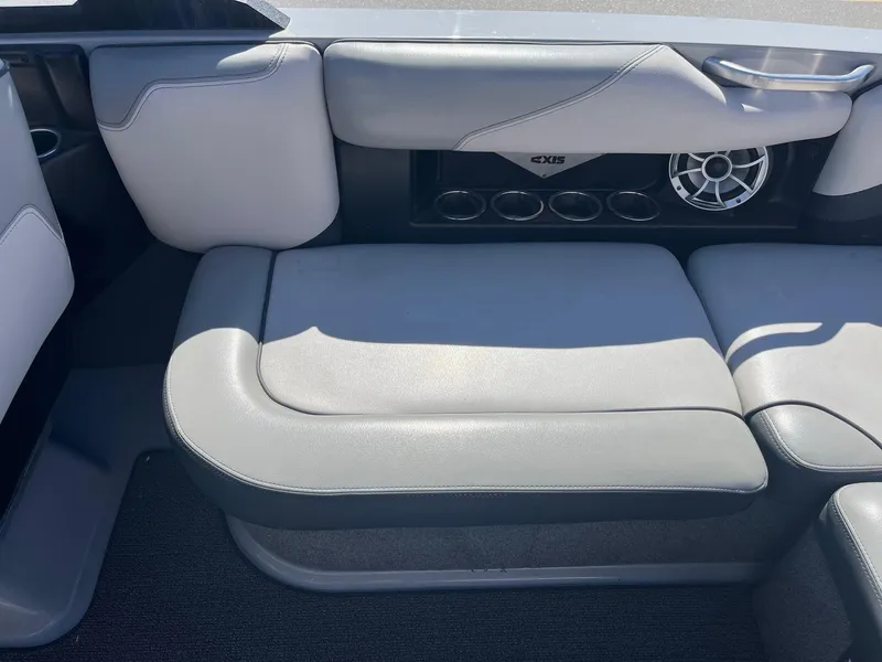 Slide: The Image of 2017 Axis Boats T22 interior seating with cup holders and speaker. - 21