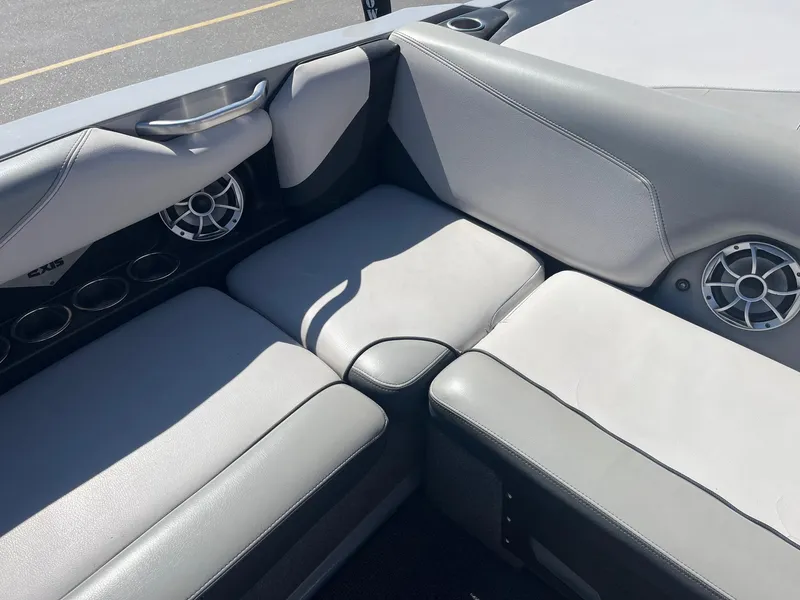 Slide: The Image of 2017 Axis Boats T22 interior with gray seating and built-in speakers. - 22