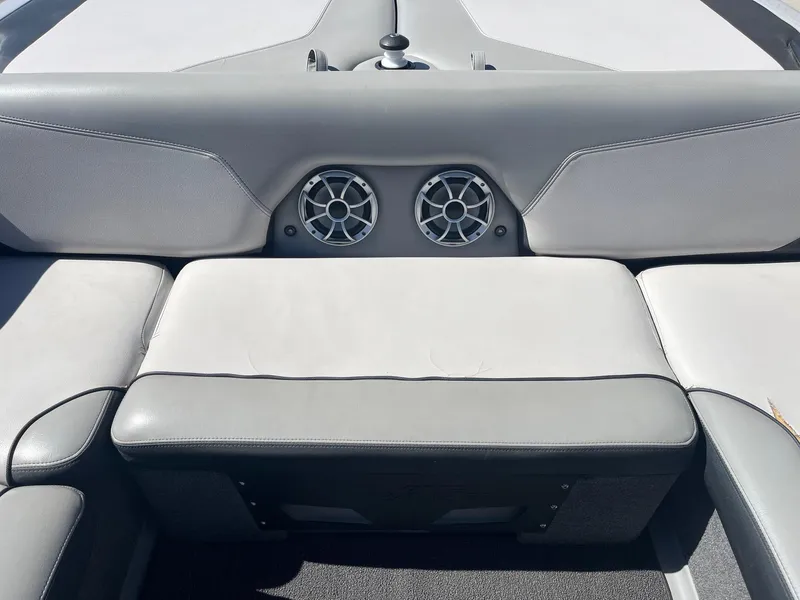 Slide: The Image of 2017 Axis Boats T22 interior with gray seating and dual speakers. - 23