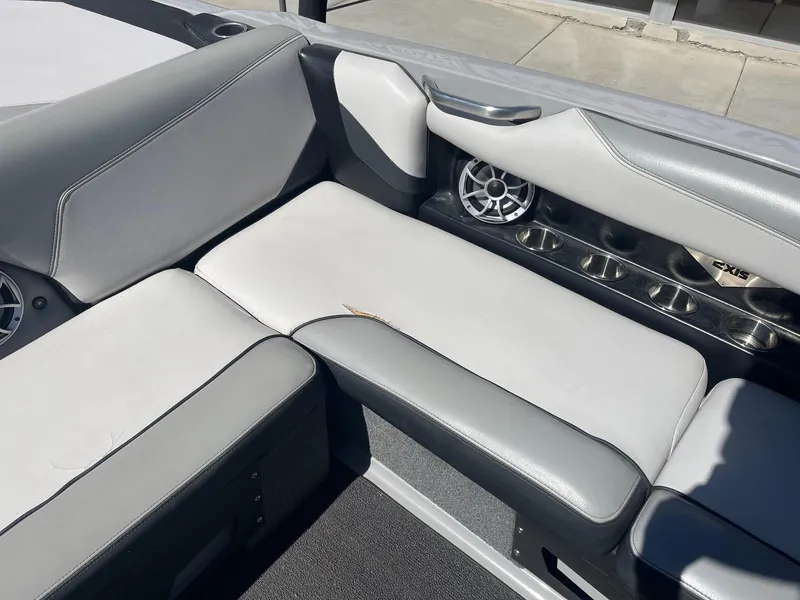 Slide: The Image of 2017 Axis Boats T22 interior with gray seating and built-in speakers. - 24
