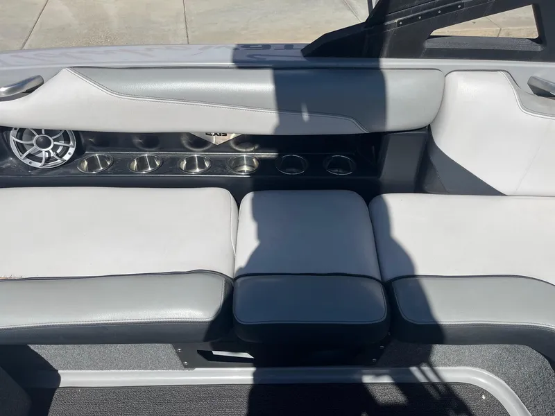 Slide: The Image of 2017 Axis Boats T22 interior with gray seating and cup holders. - 25