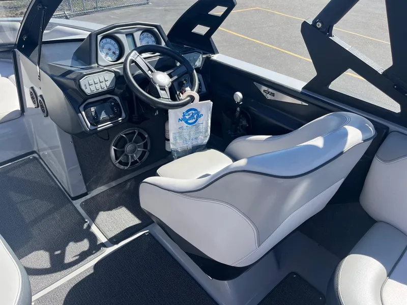 Slide: The Image of 2017 Axis Boats T22 interior with steering wheel and dashboard controls. - 27