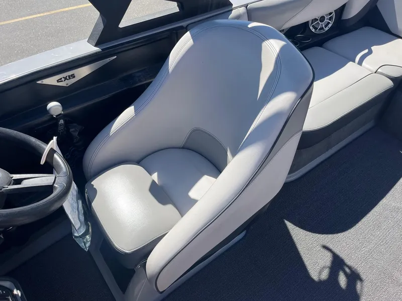 Slide: The Image of 2017 Axis Boats T22 interior with gray seating and steering wheel. - 28