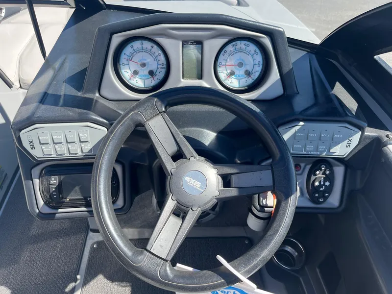 Slide: The Image of 2017 Axis Boats T22 dashboard with steering wheel and control panels. - 29