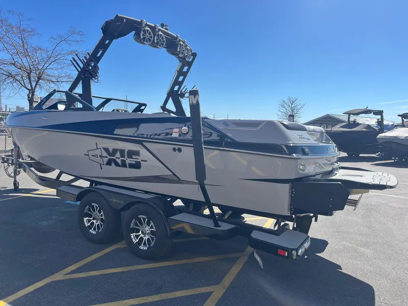 Slide: The Image of 2017 Axis Boats T22 on trailer under clear blue sky. - 8