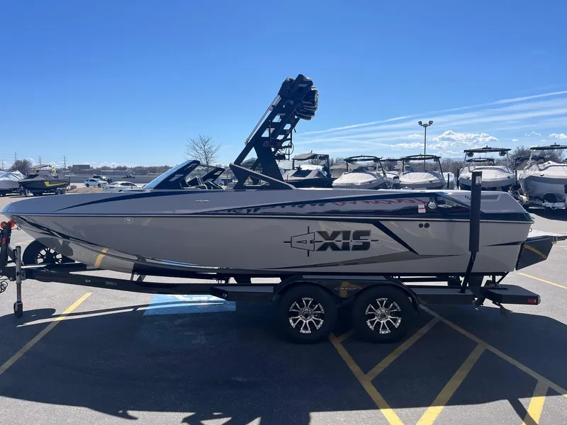 Slide: The Image of 2017 Axis Boats T22 on trailer in parking lot under clear blue sky. - 9