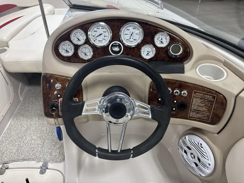 Slide: The Image of 2007 Tahoe Q8i boat dashboard with gauges, steering wheel, and control panel. - 11