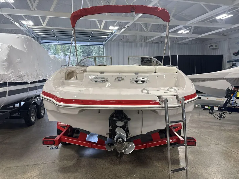 Slide: The Image of 2007 Tahoe Q8i boat in a garage, red accents, ladder, and trailer visible. - 4