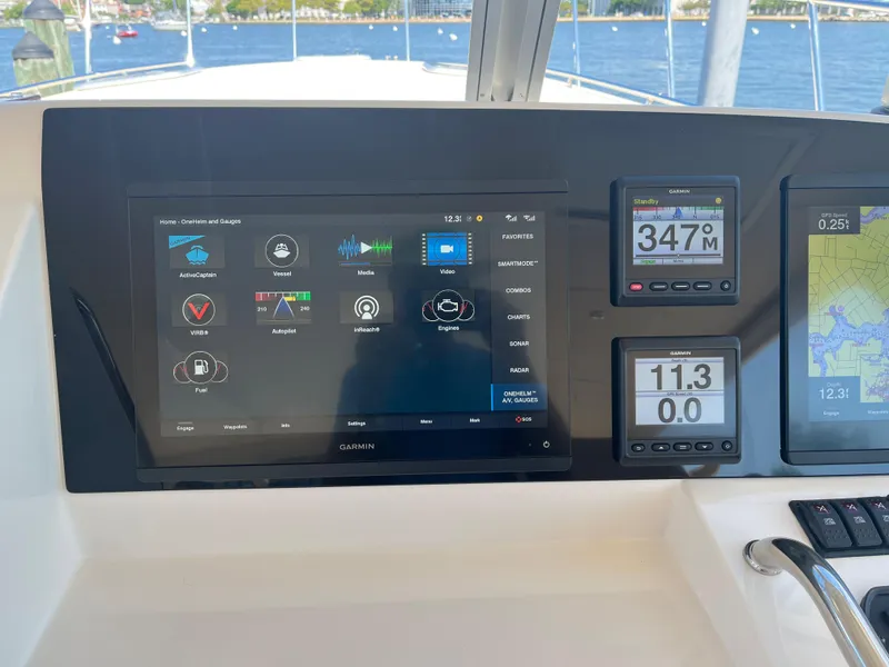 Slide: The Image of Helm dashboard of 2016 MJM 50z with navigation and control displays. - 11