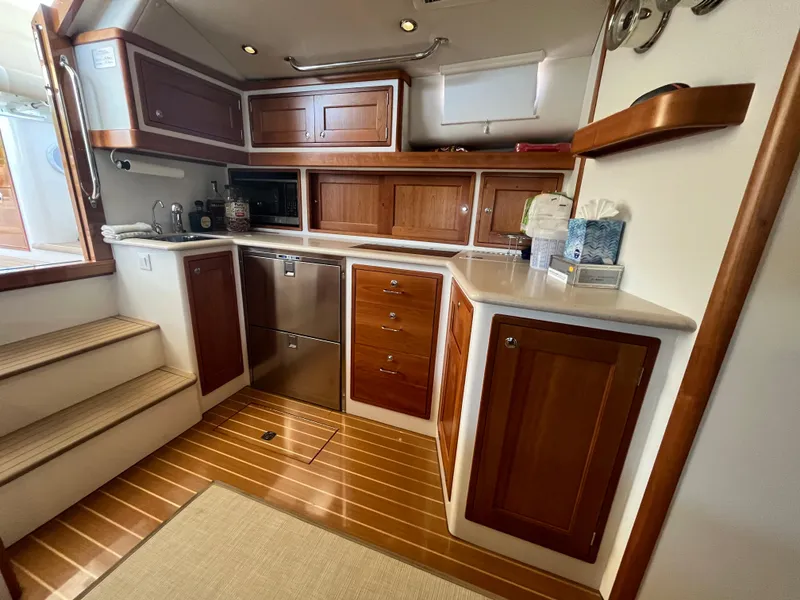 Slide: The Image of Luxurious 2016 MJM 50z yacht kitchen with wooden cabinetry and modern appliances. - 17