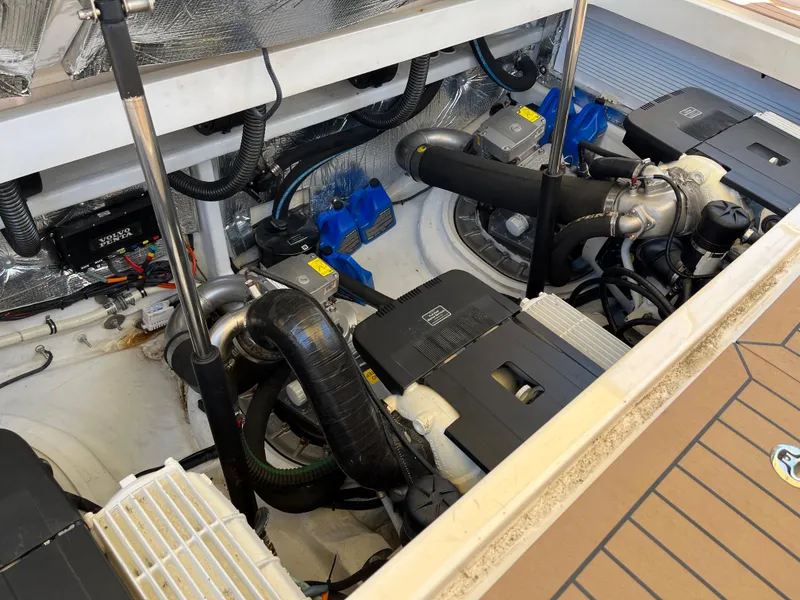 Slide: The Image of Engine compartment of a 2016 MJM 50z boat, showcasing dual engines and mechanical components. - 23