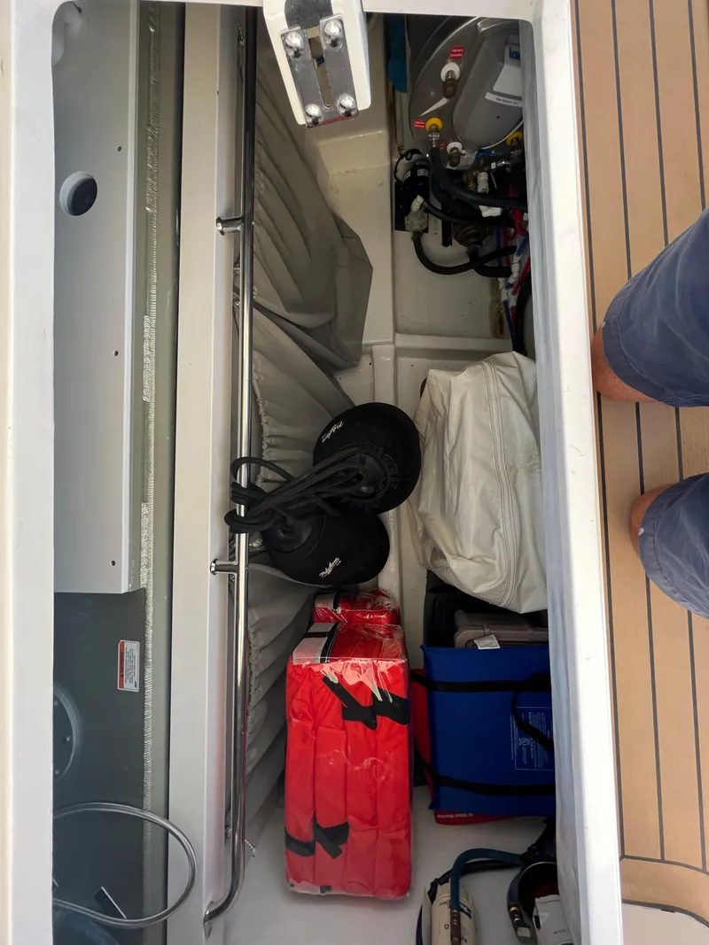 Slide: The Image of Storage compartment of a 2016 MJM 50z boat with equipment and supplies. - 27
