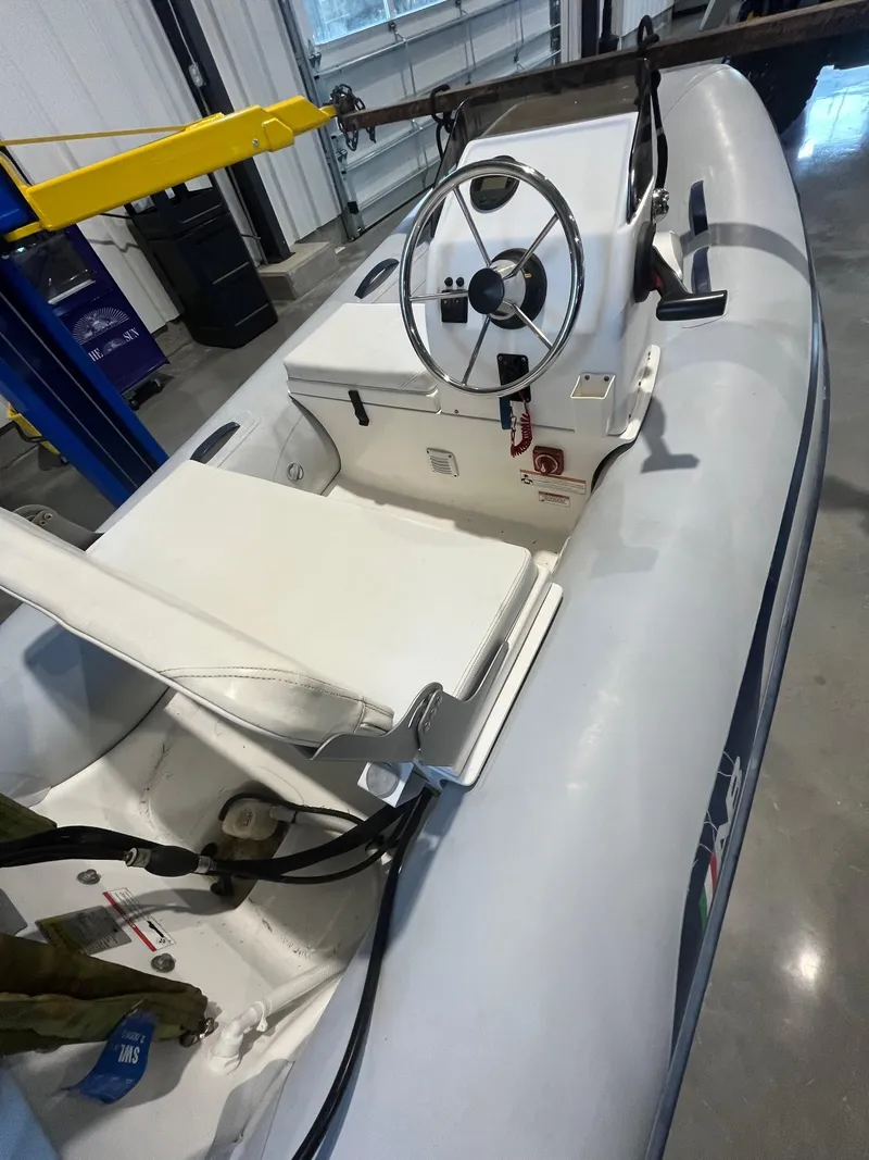 Slide: The Image of 2016 MJM 50z boat interior with steering wheel and seating in a garage setting. - 36