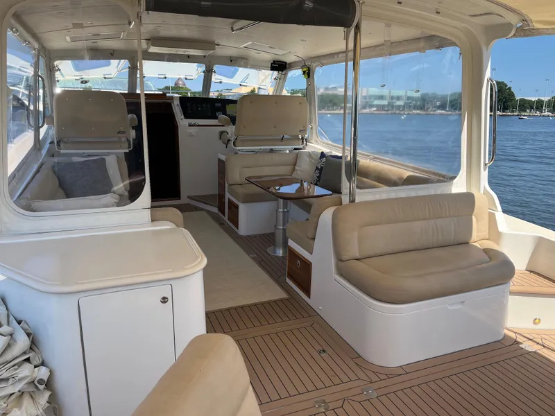 Slide: The Image of Luxurious 2016 MJM 50z yacht interior with beige seating and scenic water view. - 7