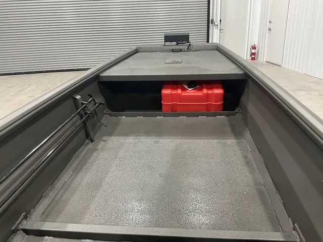 Slide: The Image of 2025 Gator Tail 1748 Gator Series boat interior with storage and red fuel tank. - 10