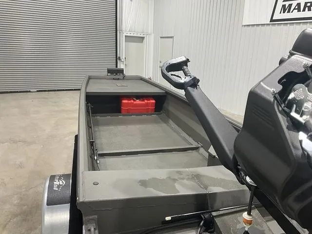 Slide: The Image of 2025 Gator Tail 1748 Gator Series boat in a garage, featuring a red fuel tank. - 11