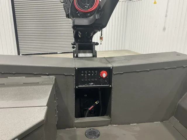 Slide: The Image of 2025 Gator Tail 1748 Gator Series boat interior with control panel and engine. - 9