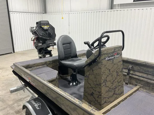 Slide: The Image of 2025 Gator Tail 1860 Extreme series boat in a garage, featuring a central seat and steering console. - 11