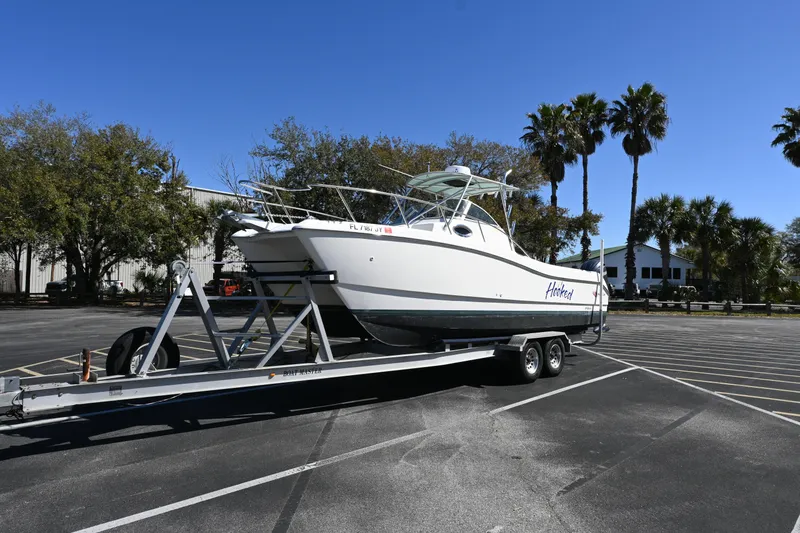 The Image of 1998 World Cat 266 SC boat on trailer in sunny parking lot. - 0