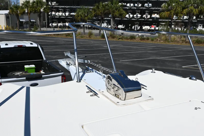 Slide: The Image of 1998 World Cat 266 SC boat on trailer, parked near palm trees and storage facility. - 14