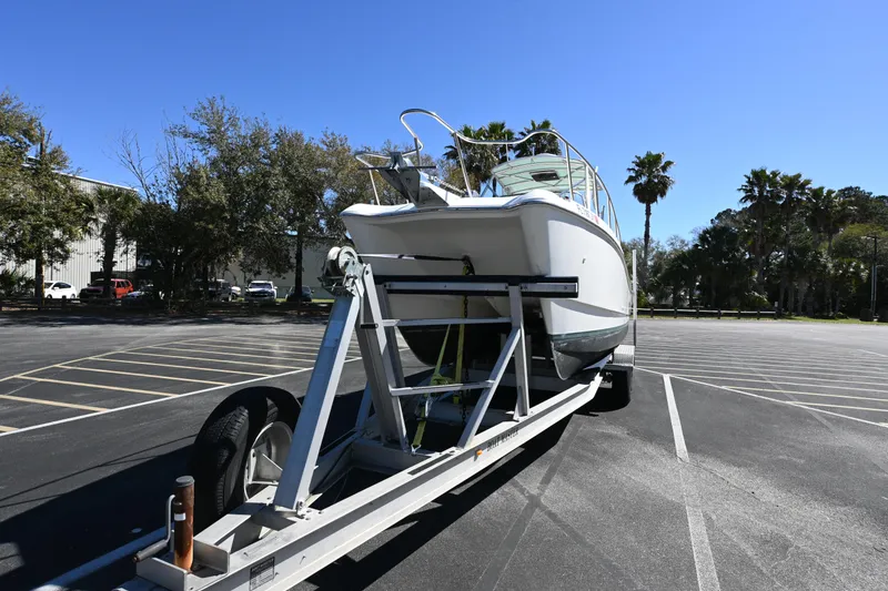 Slide: The Image of 1998 World Cat 266 SC boat on trailer in parking lot, sunny day. - 2
