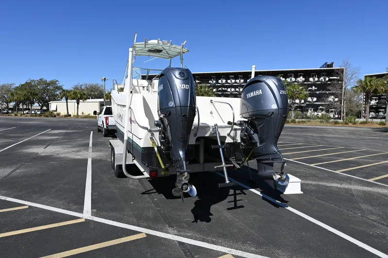 Slide: The Image of 1998 World Cat 266 SC boat with dual Yamaha outboard motors in a parking lot. - 4