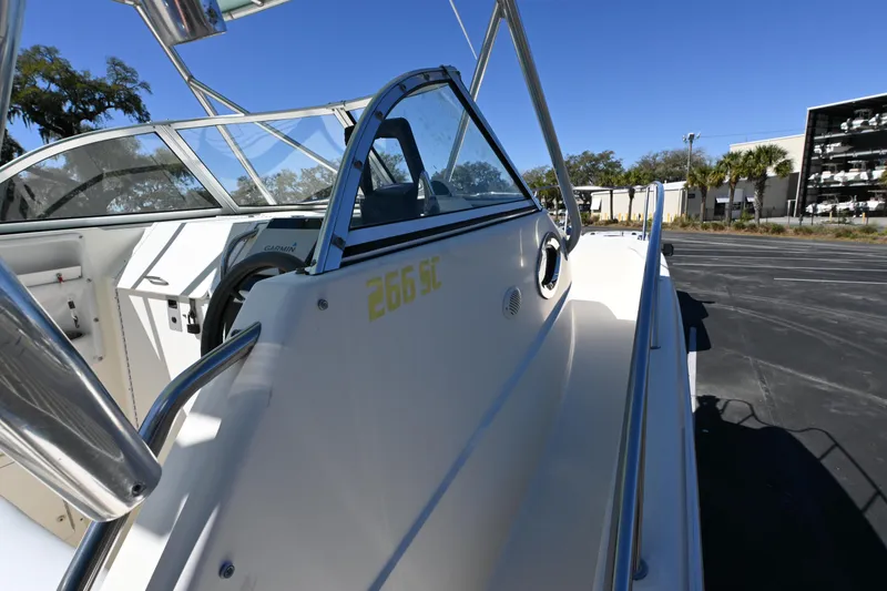 Slide: The Image of 1998 World Cat 266 SC boat, side view, showcasing sleek design and sturdy railings. - 6