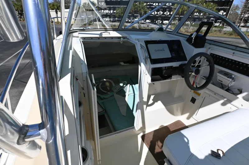 Slide: The Image of 1998 World Cat 266 SC boat interior with steering wheel and navigation equipment. - 9