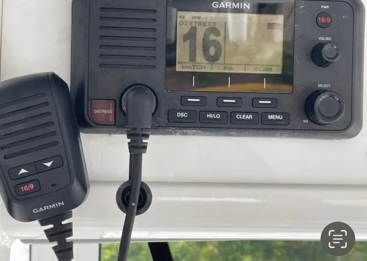Slide: The Image of Garmin marine radio on 2018 Sea Hunt Gamefish 25, displaying channel 16 distress signal. - 10