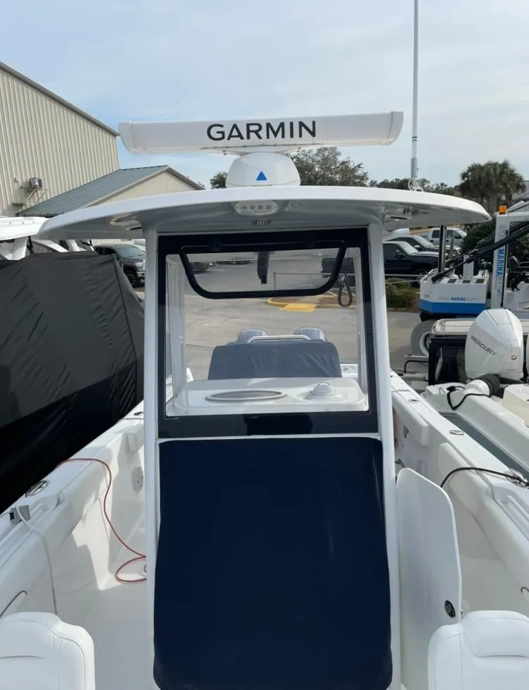 Slide: The Image of 2018 Sea Hunt Gamefish 25 boat with Garmin equipment, docked outdoors. - 11