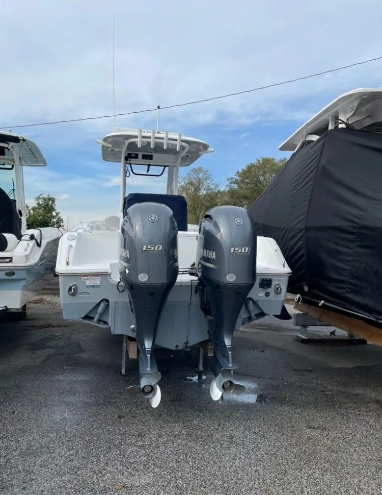 Slide: The Image of 2018 Sea Hunt Gamefish 25 with dual Yamaha 150 engines, parked outdoors. - 3