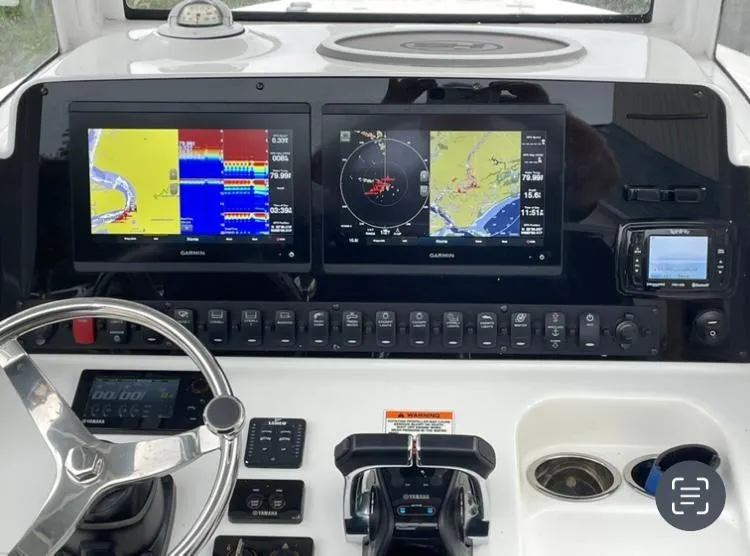 Slide: The Image of 2018 Sea Hunt Gamefish 25 dashboard with navigation screens and controls. - 6
