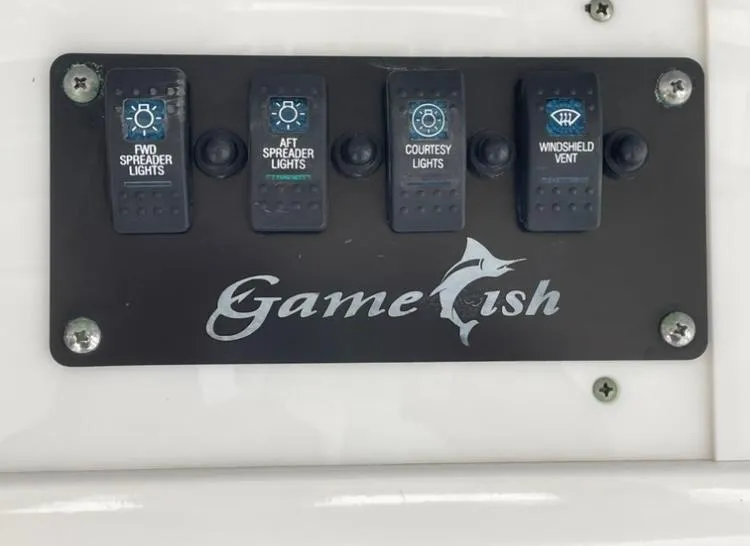 Slide: The Image of Control panel of 2018 Sea Hunt Gamefish 25 boat with labeled switches. - 9