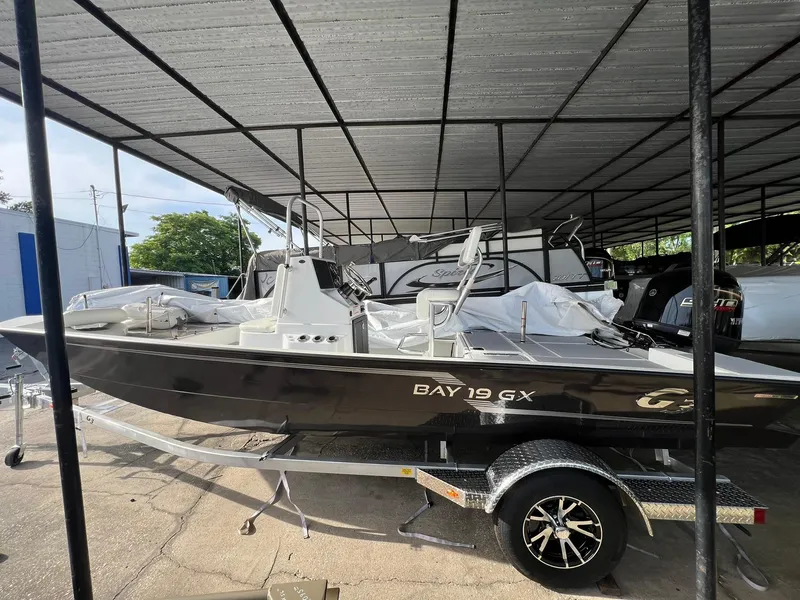 The Image of 2025 G3 Bay 19 GX boat displayed in showroom, featuring sleek design and modern seating. - 0