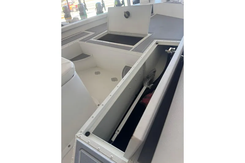 Slide: The Image of 2025 G3 Bay 19 GX boat interior with open storage compartments. - 13