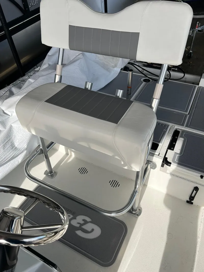 Slide: The Image of 2025 G3 Bay 19 GX boat console with steering wheel and gauges. - 2