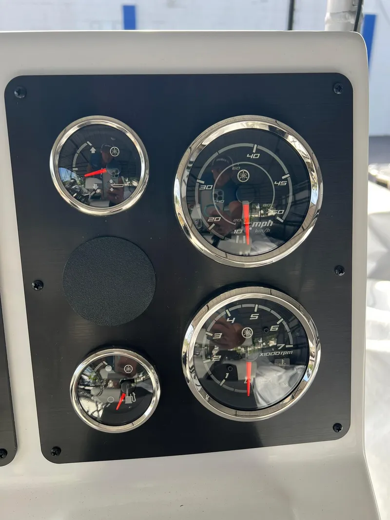 Slide: The Image of 2025 G3 Bay 19 GX boat with open storage compartment and cup holder. - 5